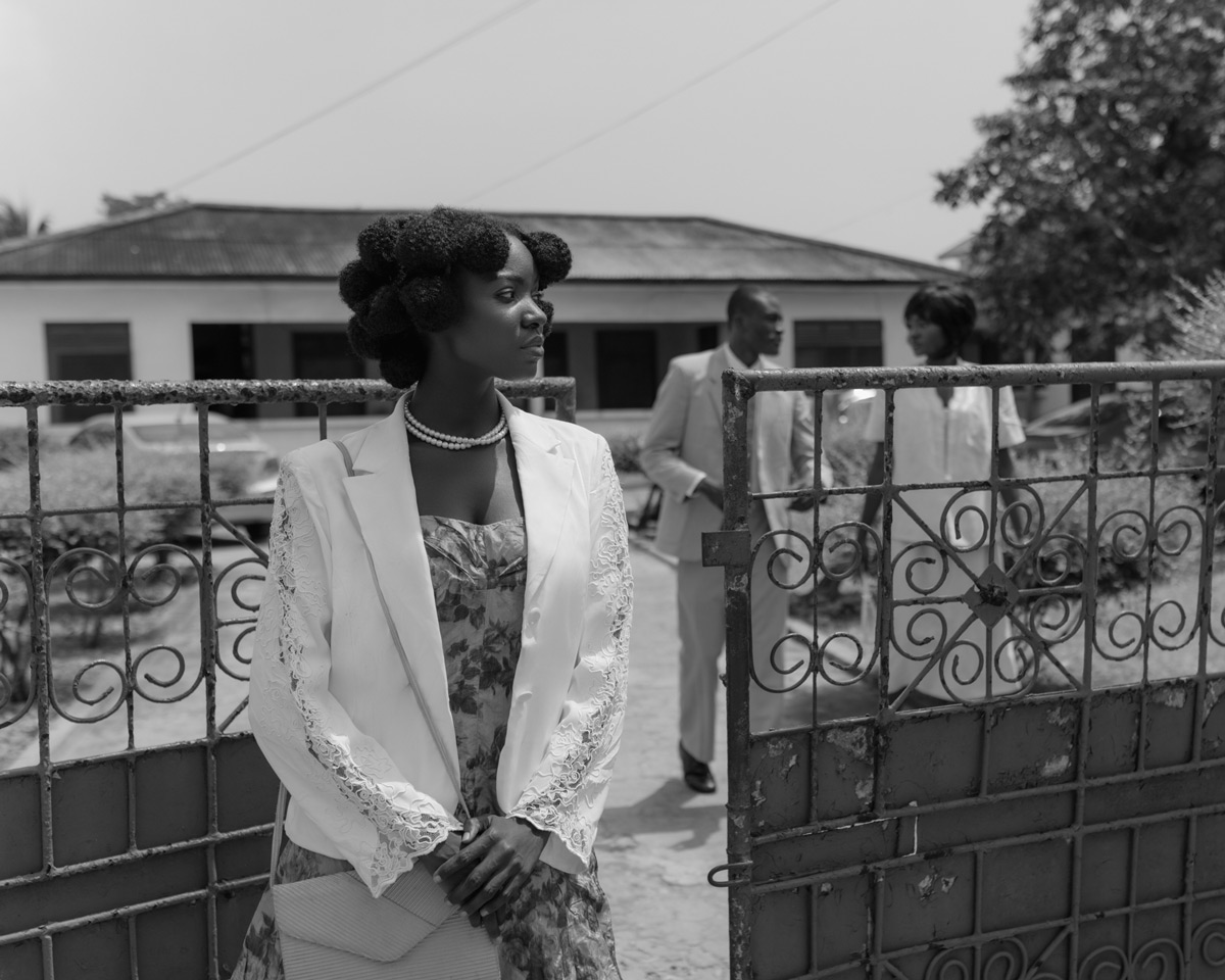 Black and white portrait of a woman outside a church in Accra, Ghana